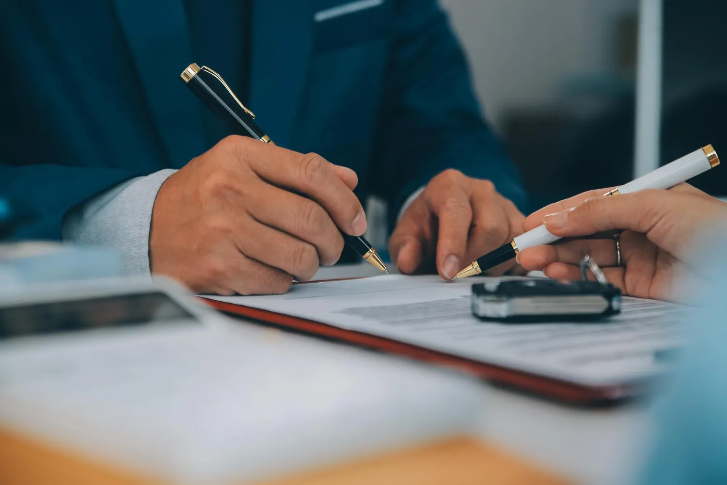 Mãos assinando documentos, discutindo inventário extrajudicial: quando ele é possível?